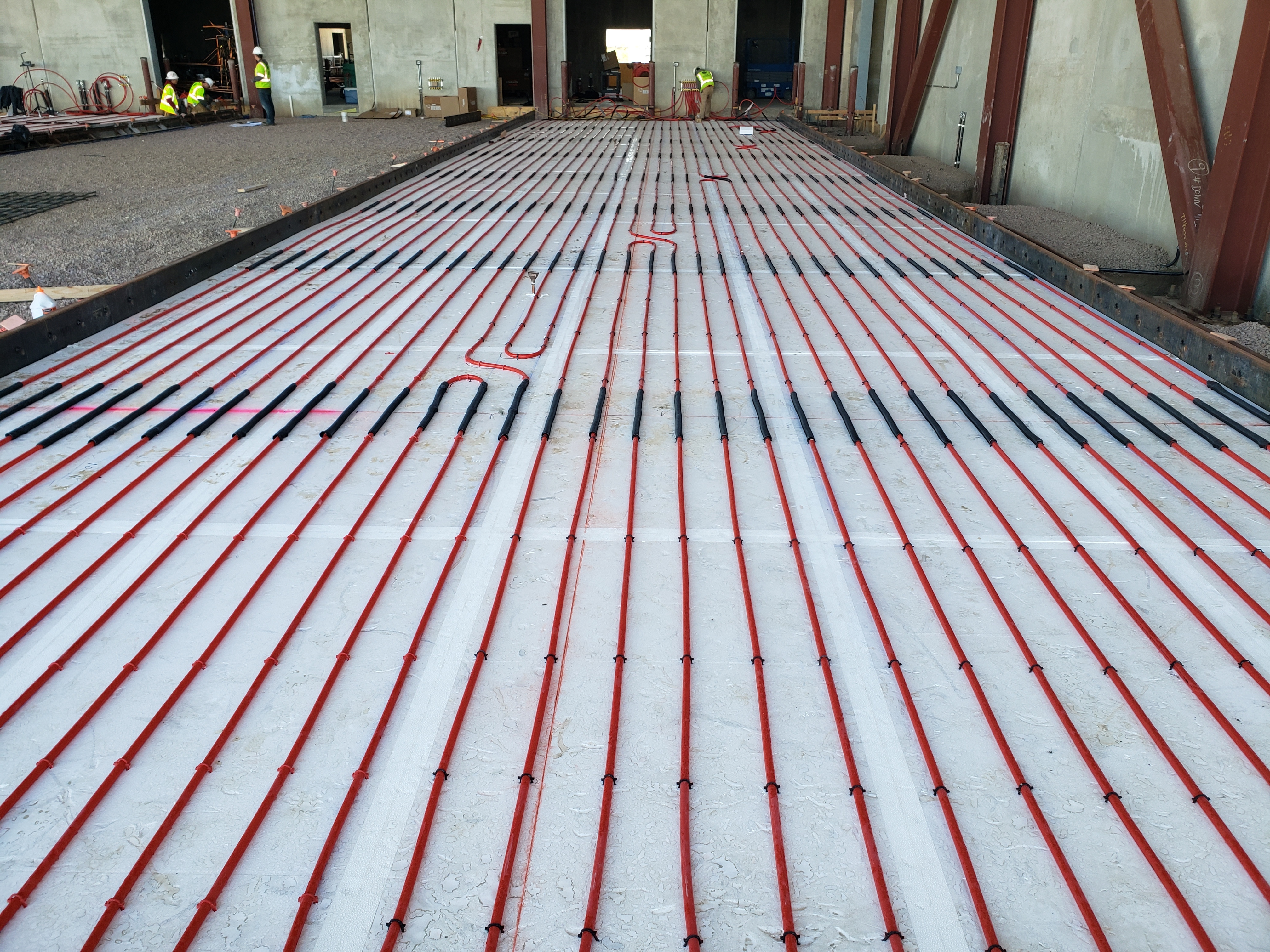 Image of ThermalStar® Below Grade Insulation. There are workers at the far end of the image wearing neon yellow shirts.