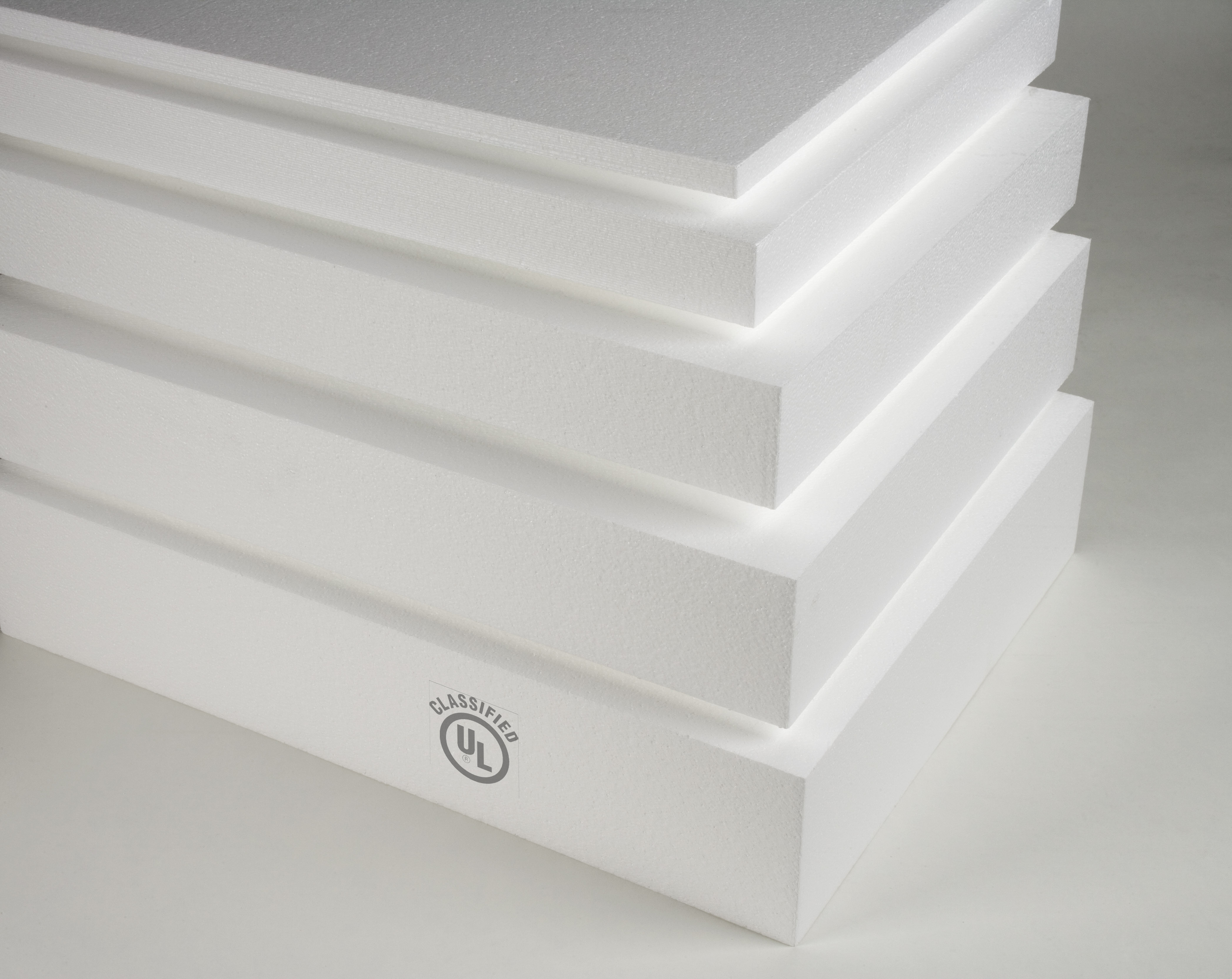 Stack of five white insulation foam boards