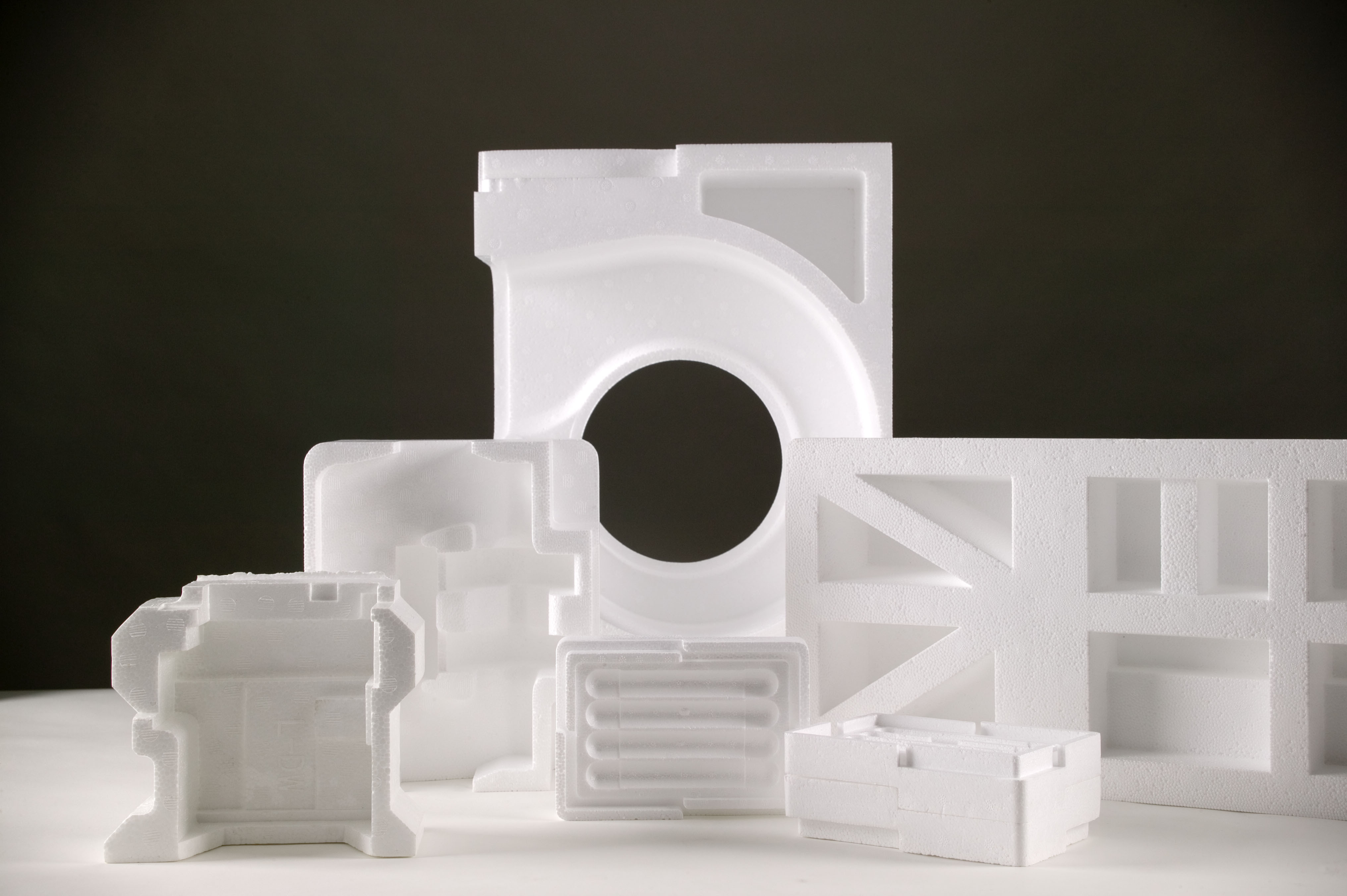 Several custom Atlas protective packaging products against a black background.