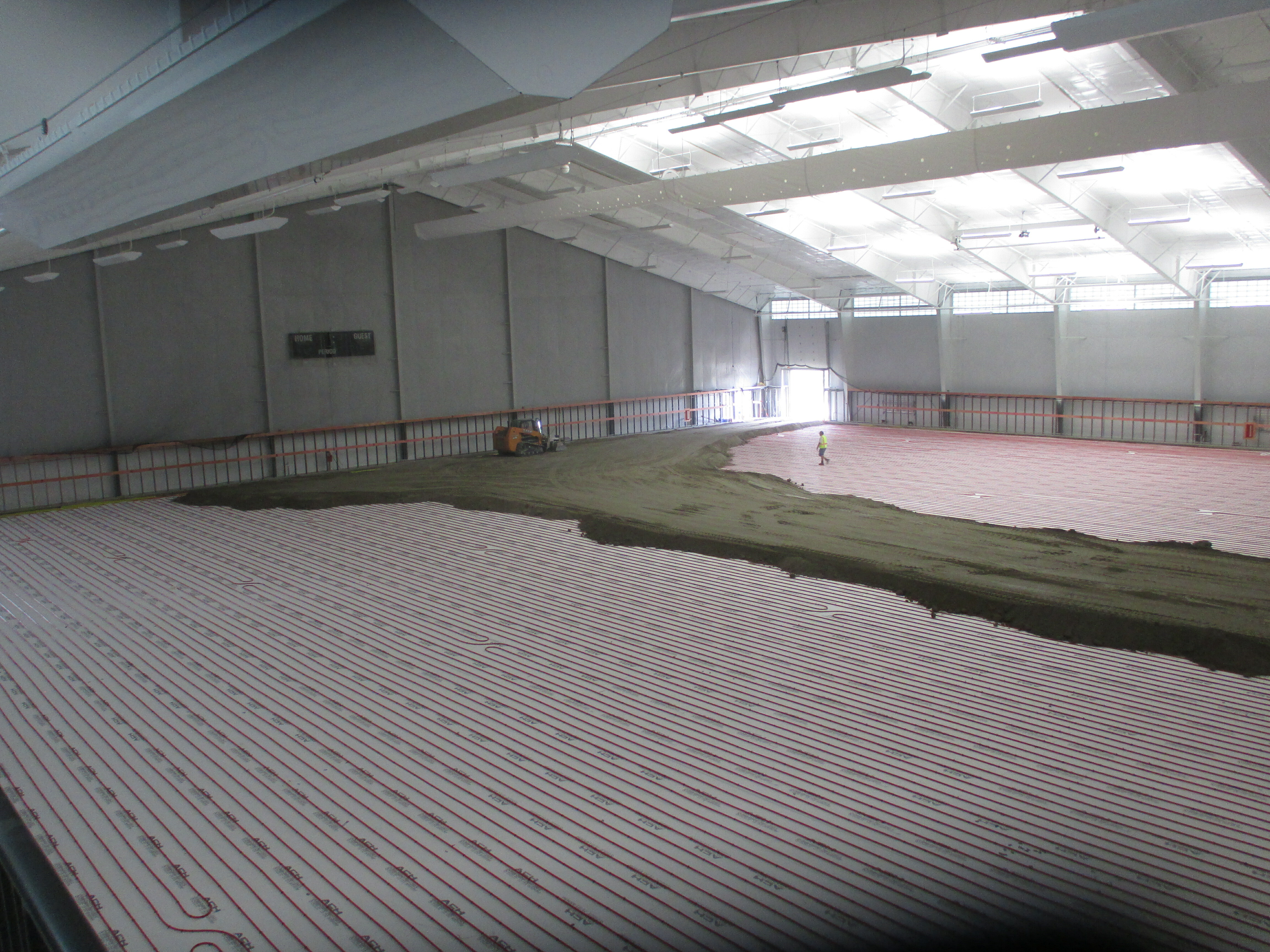 Radiant heating components installed over below-grade insulation boards.
