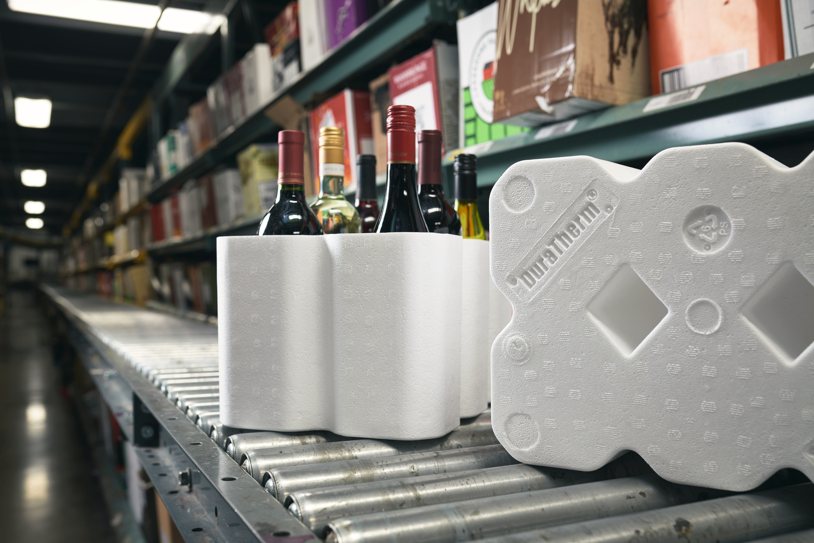 An open Atlas wine shipper is placed on a table. The shipper is holding six bottles of wine.