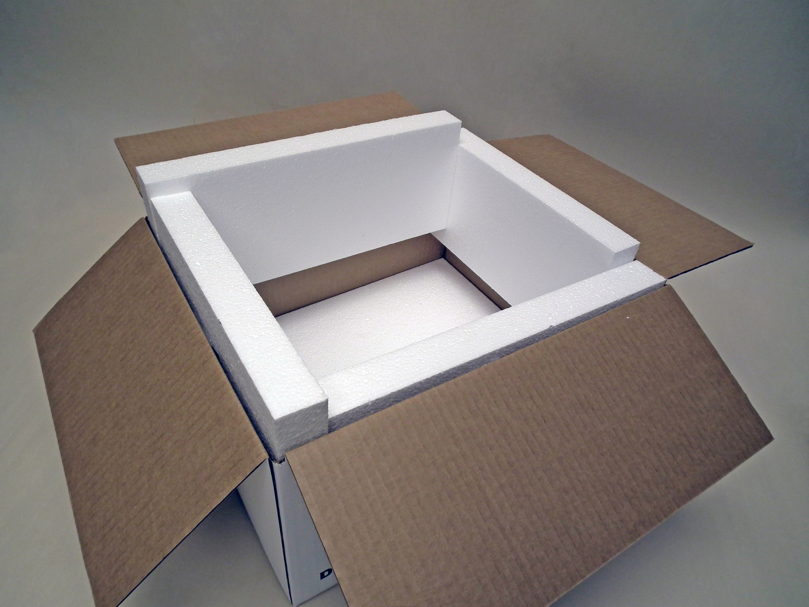 Cardboard box fitted with protective packaging foam walls.