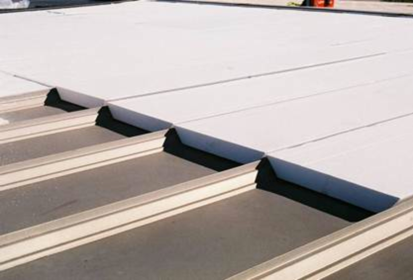 White, tapered EPS rigid insulation boards laid out on roof.